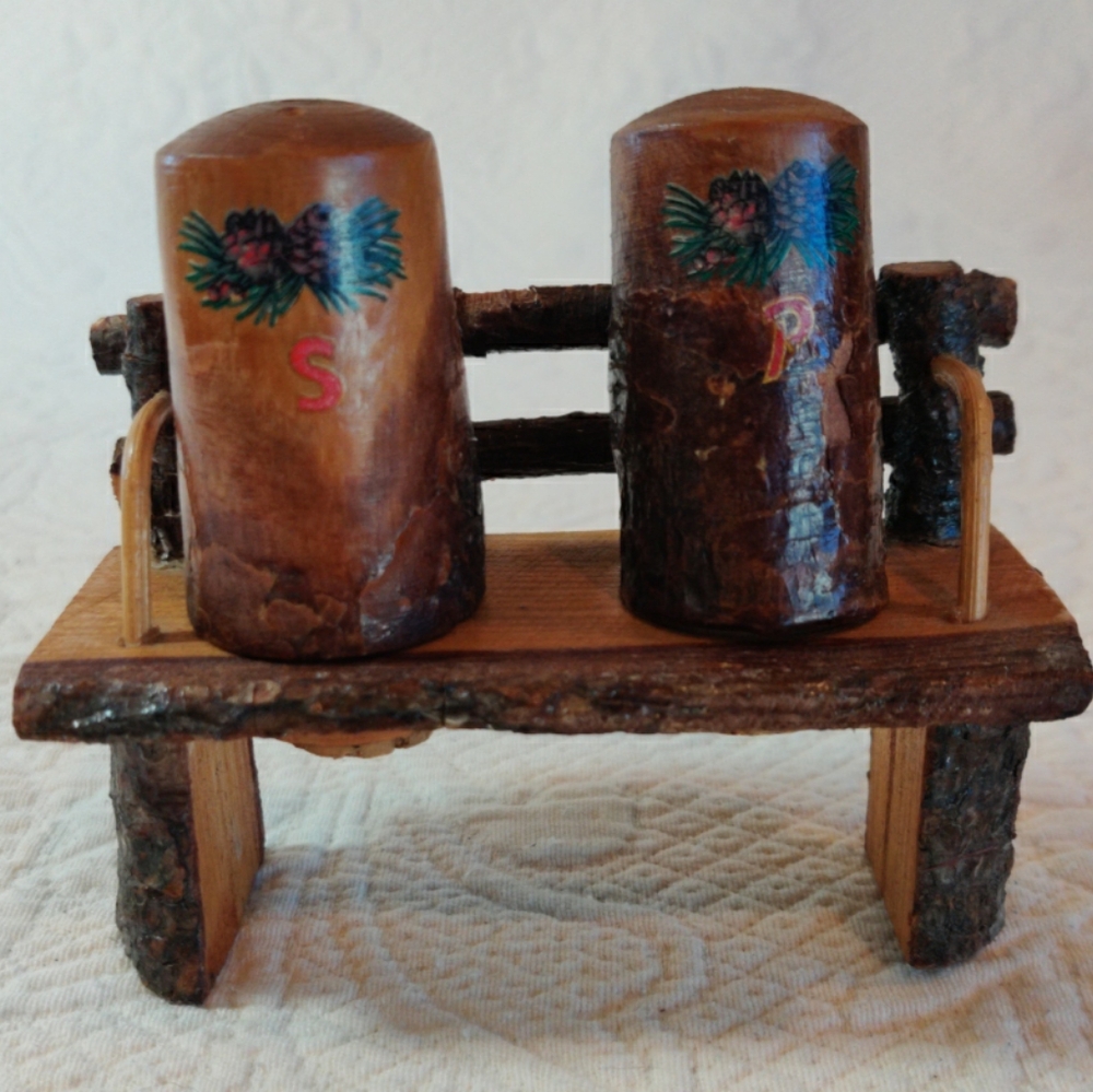 Vintage Wood Carved Salt And Pepper Shakers On A Bench Made In Japan